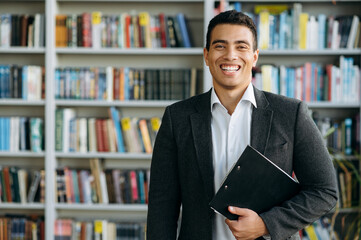 Portrait of influential hispanic male business leader. Attractive entrepreneur looks at the camera and smiling, show confidence and success