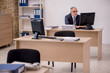 © Elnur - Aged businessman employee sitting in the office