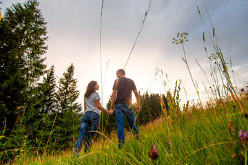 Happy young couple enjoy walking forest. Pure nature scenery