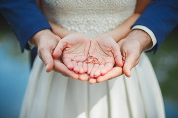 bride and groom hold rings in their palms. wedding.