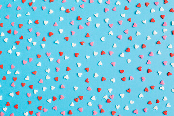 Wall Mural - Valentine's Day background February 14th. Red, pink, white hearts confetti on bright blue background. Valentines day creative concept. Flat lay, top view, copy space.