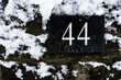 Number 44 in a covered with snow brick wall