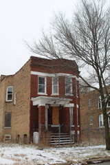 Abandoned red brick two flat in Chicago's Englewood neighborhood on the South Side