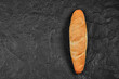 Fresh wheaten baton bread on dark background