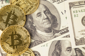 Wall Mural - Bitcoin cryptocurrency on hundred us dollars. Close up electronic golden coin. Business and financial concept.