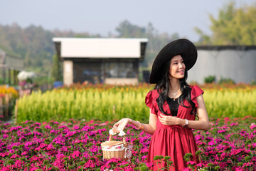 Wall Mural - Portrait of happy asian woman in the cockscomb flower garden and relaxing on holiday