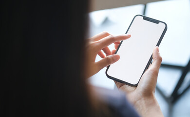 close up view of businesswoman holding mobile phone with blank screen.