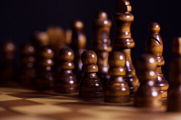 Wall Mural - Wooden chess in a contrasting light. A game of chess, an intellectual competition,