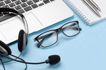 Wall Mural - Office desk with headset, glasses and laptop