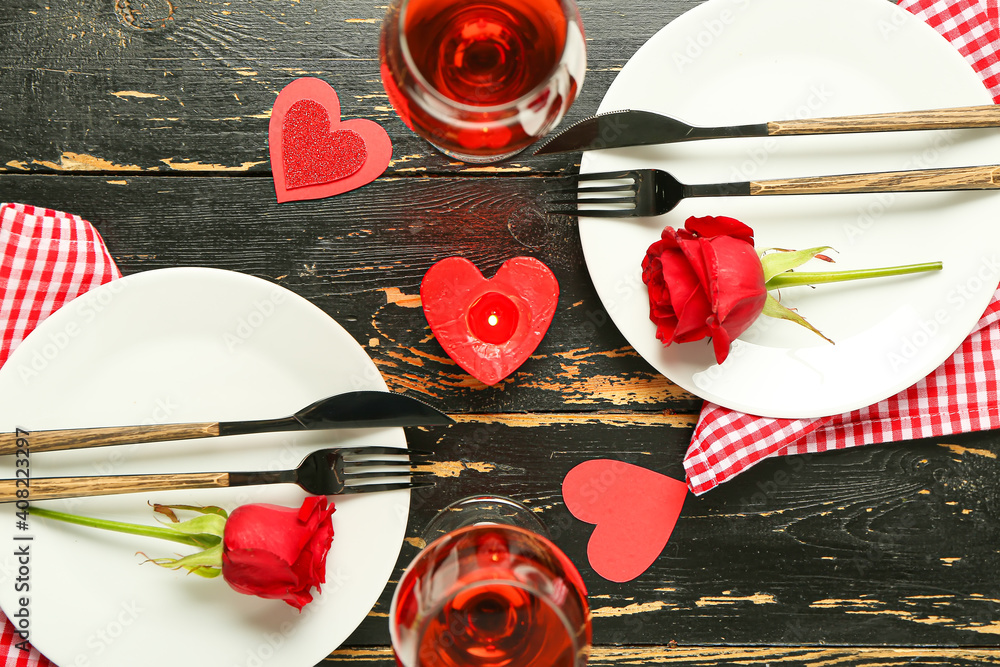 Festive table setting for Valentines Day celebration on dark wooden background