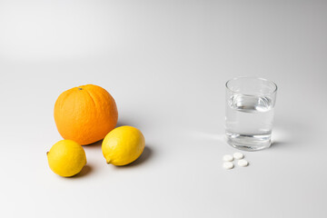 Citruses, a glass of water and medicines