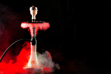 Smoking hookah on black background with color fog