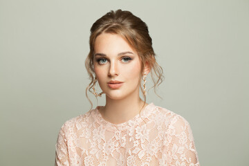 Young woman looking at camera on white background