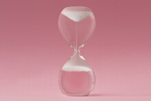 Upside-down Hourglass On Pink Background - Concept Of Reverse Time