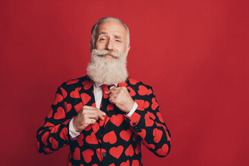 Sticker - Photo of bearded gentleman adjust tie self-assured look camera wear heart print suit isolated red background