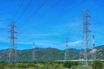 High voltage lines at mountain landscape.