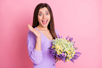 Sticker - Profile photo of impressed girl hold flowers wear lilac sweater isolated on pink color background