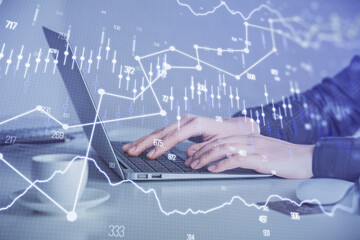 Double exposure of businesswoman hands typing on computer and forex graph hologram drawing. Financial analysis concept.