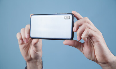 Man taking a picture with smartphone.