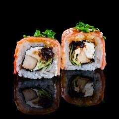 Wall Mural - Concept of Asian cuisine. Two rolls of sushi with different fillings on a black background for Japanese menu. two sushi rolls couple isolated with reflection