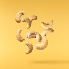 Wall Mural - Fresh tasty Cashew nuts falling in the air