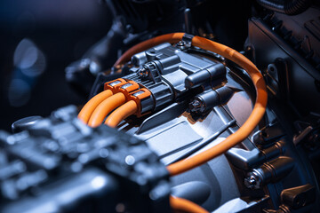 Chassis of the electric car with powertrain and power connections closeup. Blue toned. EV car drivetrain at maintenance.