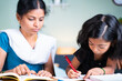 © WESTOCK - selective focus on kid Mother helping her kid for doing school homework - concept of parenthood, assistance, relationship and bonding.