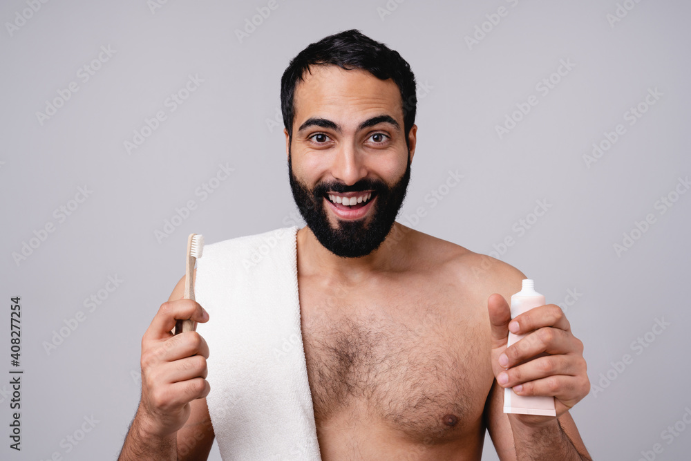 Excited attractive muslim naked man with towel and toothbrush and