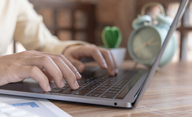 Close-up of a woman's hand pressing on the laptop keyboard, World of technology and internet communication, Financial professionals use laptop to calculate and check real estate earnings.