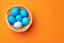 Easter Eggs In A Nest On Orange Background
