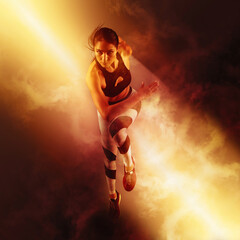 Wall Mural - Sporty young woman running on smoke background