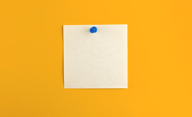 Pinned notepad sheet of square paper on isolated yellow background, for message and work letters