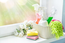 Spring Cleaning Concept - Cleaning Supplies And Flowers On Blur Background, Copy Space