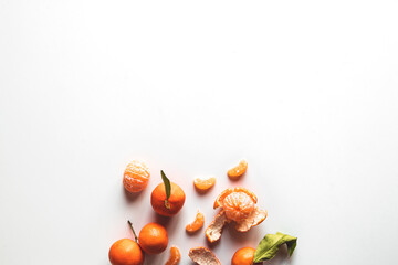 Wall Mural - Oranges fruits composition with green leaves and slice on white wooden background, top view