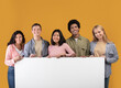 © Prostock-studio - Diverse teens cheerful international students holding big banner with free space and ready to study