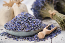 Blue Plate Of Dried Lavender. Wooden Scoop Of Dry Lavender Flowers. Lavender Bouquet And Sachets On Background.