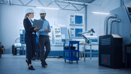 Aufkleber - Female Chief Engineer and Male Project Manager Walk Through Modern Factory, Talking and Planning Optimization of the Production. Industrial Facility: Professionals Working on CNC Machinery, robot arm