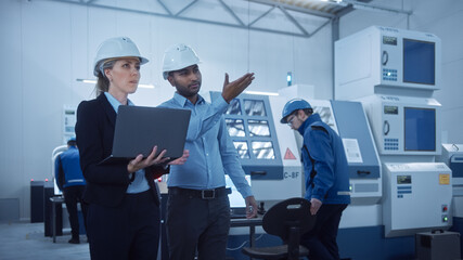 Aufkleber - Female Chief Engineer and Male Project Manager Use Laptop in Modern Factory, Talking and Planning Optimization of the Production. Industrial Facility: Professionals Working on CNC Machinery, robot arm