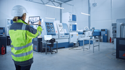 Poster - Industry 4.0 Modern Factory: Female Engineer Uses Digital Tablet Computer with Augmented Reality to Visualize Workshop Mapping, Floor Layout. Facility with High-Tech CNC Machinery and robot arm