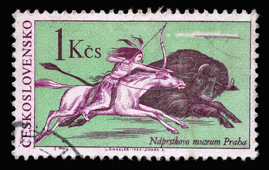 Wall Mural - Stamp printed in Czechoslovakia shows the scene of buffalo hunting, a native American Indian on horseback, pursue a bison galloping, circa 1966