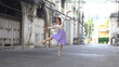 © witthaya - Young beautiful ballerina dancing along the street