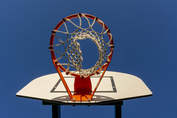 Sticker - Low angle shot of a basketball hoop and the plain blue sky