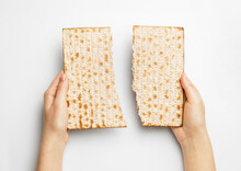 Hands With Jewish Flatbread Matza For Passover On White Background