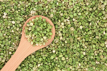 Poster - Vegan healthy roasted green peas in a wooden spoon & forming a background. High in dietary fibre, protein, vitamins & minerals & have many health benefits. Flat lay, top view.