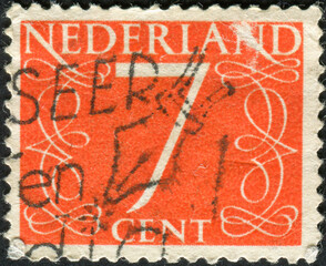 Wall Mural - NETHERLANDS - CIRCA 1953: Postage stamp printed in the Netherlands, shows number seven