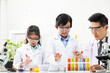 © BritCats Studio - Young Asian kids wearing white scientist gown and do chemical test tube while study, learning in science classroom with teacher. Young children education concept by experiment, fun and enjoy classroom
