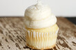 vanilla cupcake with sweet frosting and white sprinkles
