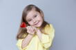 valentine's day caucasian child holding a lollipop heart over grey background.Donation,heart health,world heart day, world health day,world mental health day.Health and heart concept.Selective focus.
