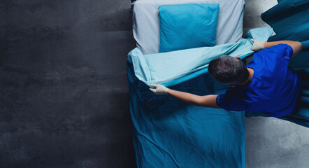 Wall Mural - Healthcare worker doing the bed in hospital, coronavirus concept.