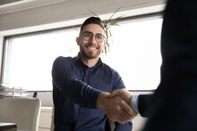 Close Up Smiling Arabian Candidate Wearing Glasses Shaking Employer Hand, Getting Job, Hr Manager Congratulating Successful Seeker, Diverse Business Partners Greeting, Good First Impression Concept